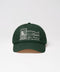 Green cap with white embroidery on a light gray background